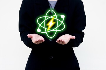 Business person holding glowing atom icon with lightning bolt, symbolizing nuclear energy,...