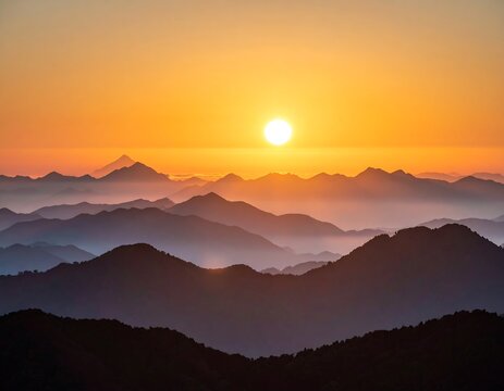 Sunrise over layered mountain ranges