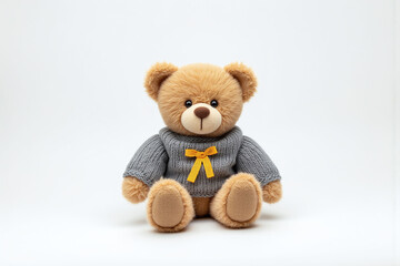 Fototapeta premium teddy bear wearing a sweater with a yellow ribbon on it