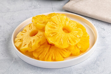 Sweet canned pineapple slices in syrope
