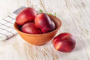 Ripe sweet juicy flat nectarines heap