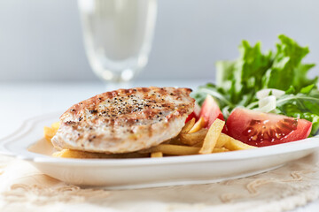 Grilled Turkey Breast with fresh salad. Bright background.	