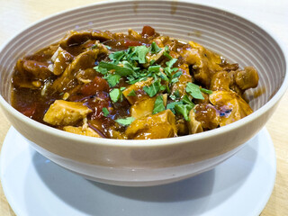 Delicious bowl of savory chicken stew garnished with fresh herbs