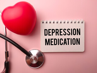 Red heart shape and statehoscope with the word DEPRESSION MEDICATION on a pink background