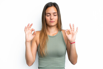 Young caucasian woman isolated on white background in zen pose