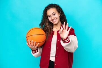 Arab basketball player woman isolated on blue background happy and counting three with fingers