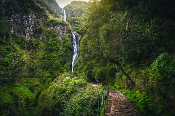 Stunning levada hiking trail and high waterfall, Madeira Island, Portugal