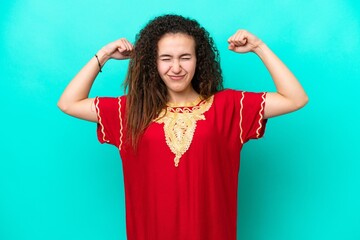 Young Arab woman isolated on blue background doing strong gesture