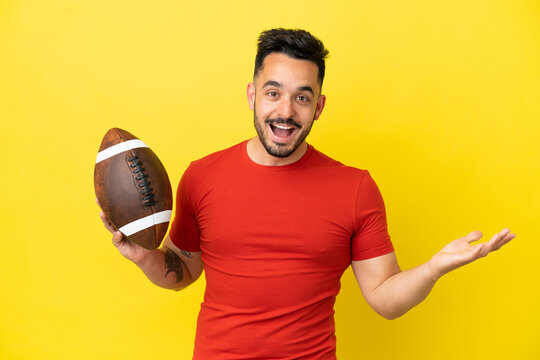 Young Caucasian man playing rugby isolated on yellow background with shocked facial expression