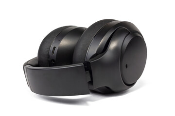 A sleek, black over-ear wireless headphone is isolated against a clean white background. The soft earcups and padded headband suggest comfort.