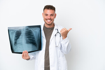 Professional traumatologist caucasian man isolated on white background pointing to the side to...