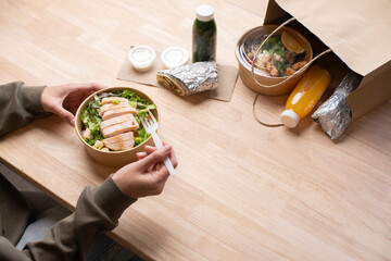 Asian woman eating healthy meal while working, Businesswoman having a lunch break at the office