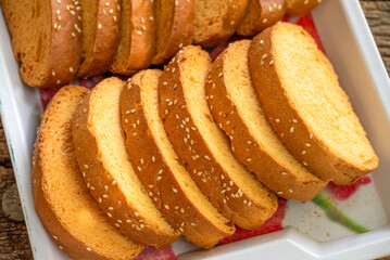Crispy rusk, Biscuits cake rusk over wooden background , a crunchy snack infused with traditional...