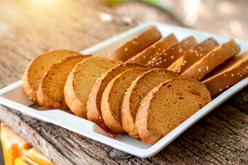 Crispy rusk, Biscuits cake rusk over wooden background , a crunchy snack infused with traditional spices, perfect for tea or coffee. A delightful treat for your mornings or tea time