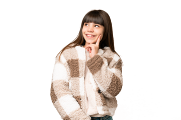 Little girl over isolated green chroma key background thinking an idea while looking up