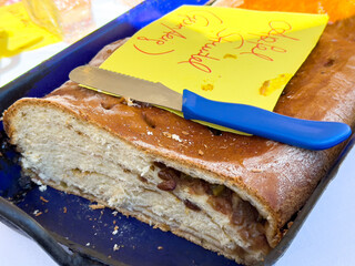 Homemade sweet bread with raisins and knife on tray