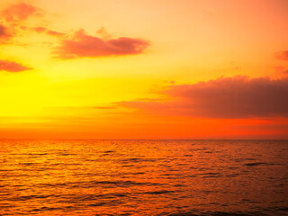 Fototapeta premium Sea sunset sky evening sunrise cloud weather dramatic landscape goldent and indigo color gradient pastel horizon, twilight yellow golden reflection morning nature environment energy ecosystem change.
