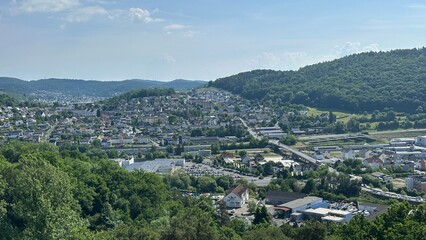 Obraz premium Panoramic view of the charming town of Herborn, Germany, captured from the top of the Aussichtsturm Dillblick observation tower. The image reveals a picturesque blend of historic rooftops, green hills
