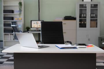 Workspace with desktop computer, office supplies, houseplant at office..