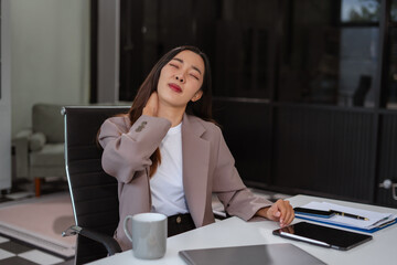 Businesswoman doing stretching pose due to sitting in office for too long.