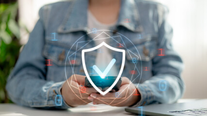Mobile cybersecurity and data protection concept. User holding smartphone with secure shield icon and binary code, symbolizing encryption, safe access, and digital privacy protection.
