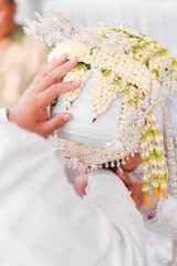 Bride and groom exchanging rings during a traditional Indonesian wedding ceremony, symbolizing their commitment and love. Asian muslim wedding	
