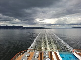 Luxury Cruise Ship Aft Deck Overlooking Ocean Waves Under Cloudy Sky