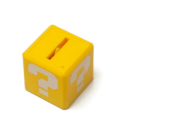 a little yellow box with a big white question mark printed on each face. It recalls a graphic element of a famous platform, isolated on white background