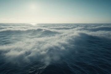 Obraz premium Frothing ocean water surface and waves under a clear sky during sunset, Frothing ocean water surface with lip of wave and mist crashing down into ocean