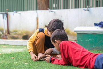 Portrait of two little children at park full of grass