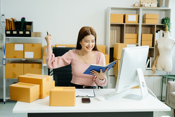 Young businesswoman managing online sales and shipping from a modern home office.