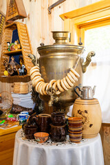 Russian samovar with steering wheels in an old Russian hut