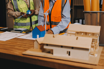 Engineers are helping to design work on blueprints and collaborate on structural analyzing of...