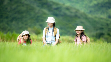 Group family children checking map in the jungle adventure.   Asia people tourism for destination leisure trips for education and relax in nature park.  Mountain background