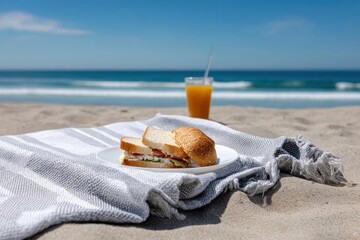 Having a delicious sandwich and juice on beach towel by the sea