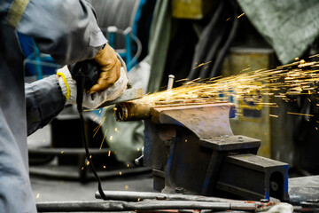 Worker are grinding metal steel