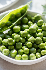 Close-up fresh green peas beans in a white plate. Macro photography