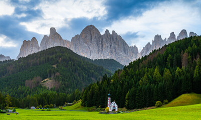 The St.John Church in Santa Magdalena in the UNESCO site mountains Dolomites in north Italy early in the morning autumn.