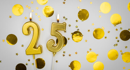 Burning Birthday candle number 25 on white background with golden confetti and glitter. Twenty-five years old. Happy Birthday. Card on festive background.