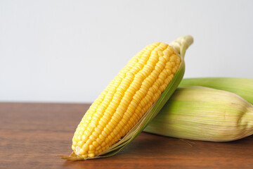 Fresh corn on wooden table background