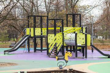 Bright playground in the park. Playground with slides and swings for children.