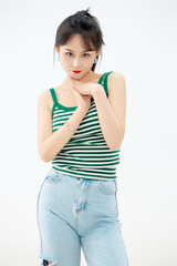Studio shot of young and beautiful Asian woman in summer outfit