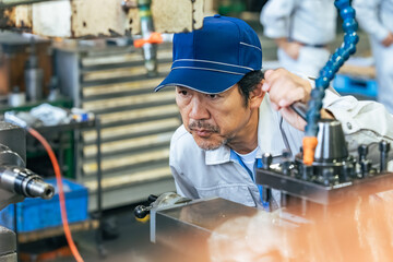 工場で機械を操作する男性作業員