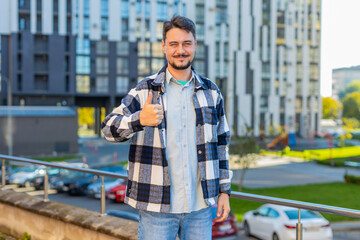 Like. Happy man raises thumb up agrees with something or gives positive reply recommends...
