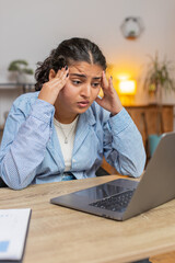 Angry furious woman freelancer using laptop while working at home office having nervous breakdown...