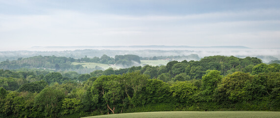 Misty morning at Crowhurst park on the high weald with views west to the south downs, east Sussex south east England UK