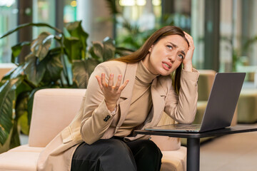 Caucasian young businesswoman girl using laptop notebook typing browsing, loses becoming surprised...
