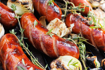 Grilled pork sausages  on a cast iron grill, close up view