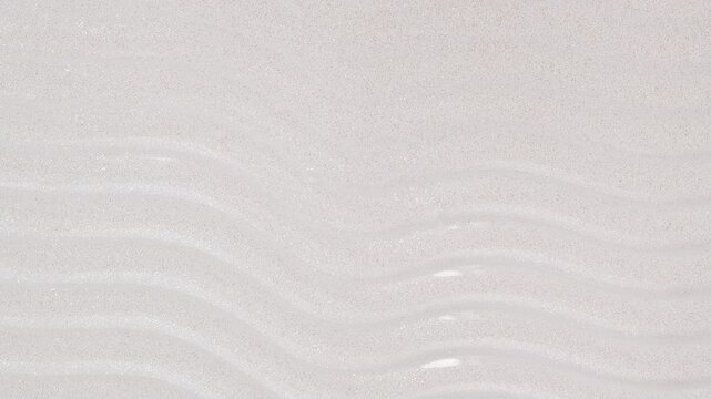 Glitter body mist texture. close-up video of the texture of a cosmetic product, 4k