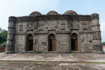 Historic Mosque with Intricate Stone Carvings and Arched Doorways